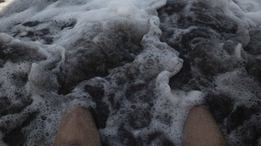 Runner using foam roller on calf muscle for injury prevention and recovery