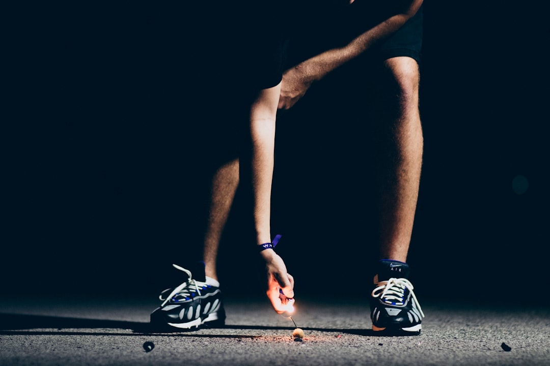 Female runner performing leg stretches on grass after a long run