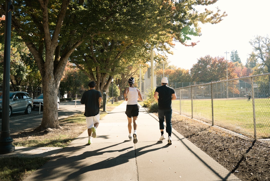 Group of runners jogging together through a park during a training session