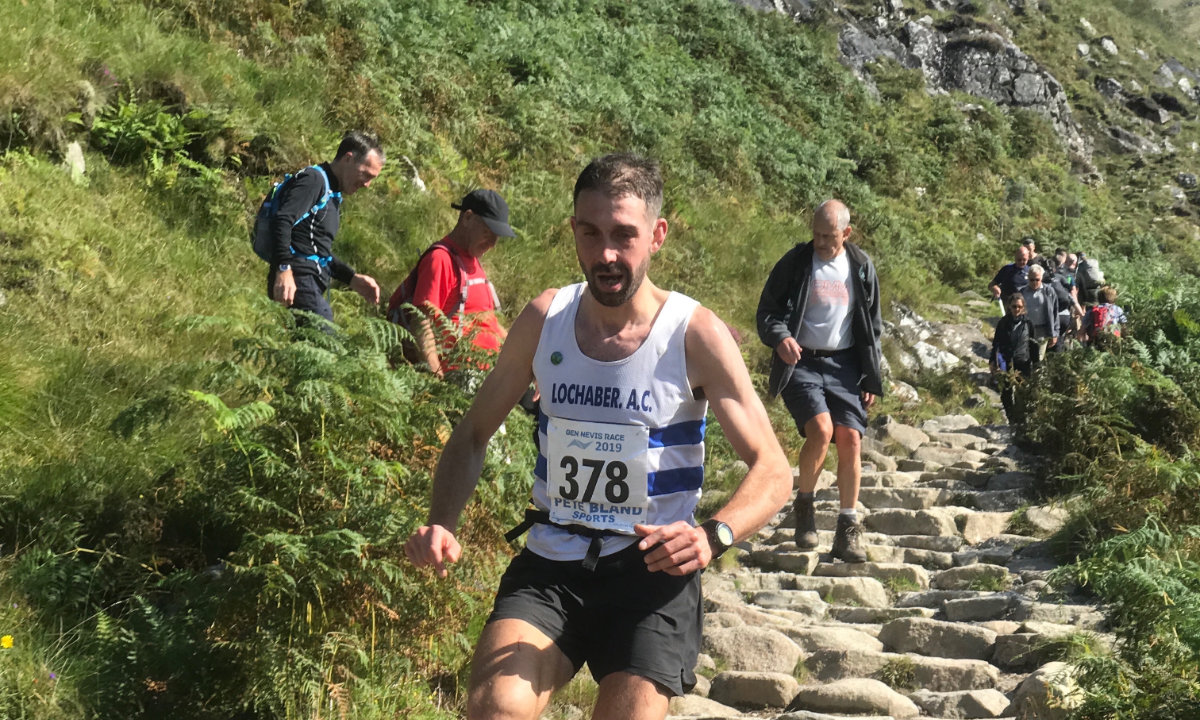 Fell runners competing on the steep slopes of Ben Nevis during a mountain race