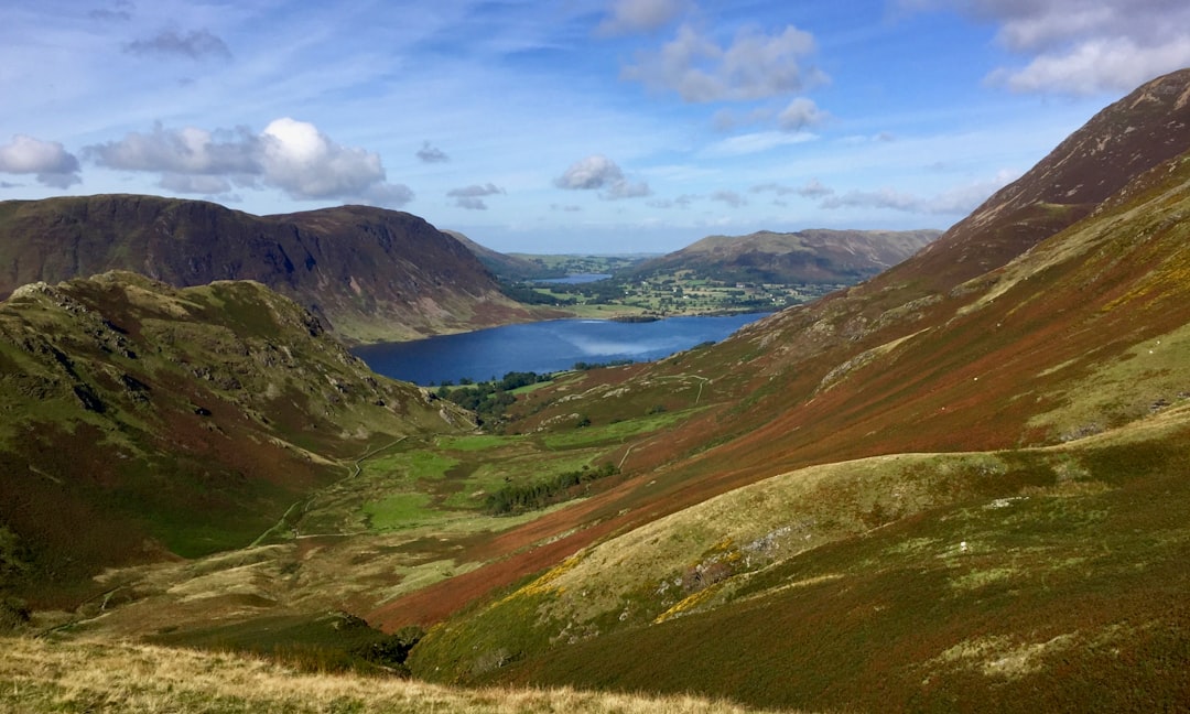 Trail runners ascending steep fell terrain in the Lake District mountains
