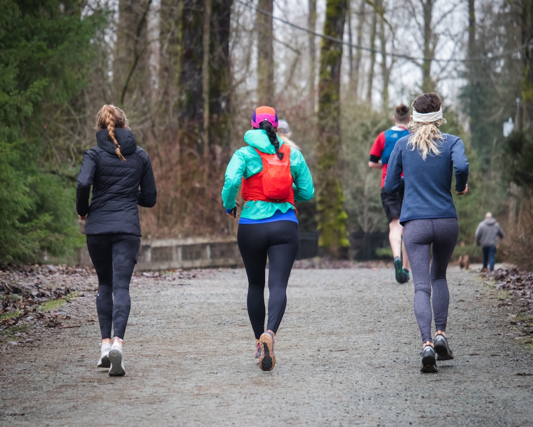 Women runners encouraging and supporting each other during a group training session