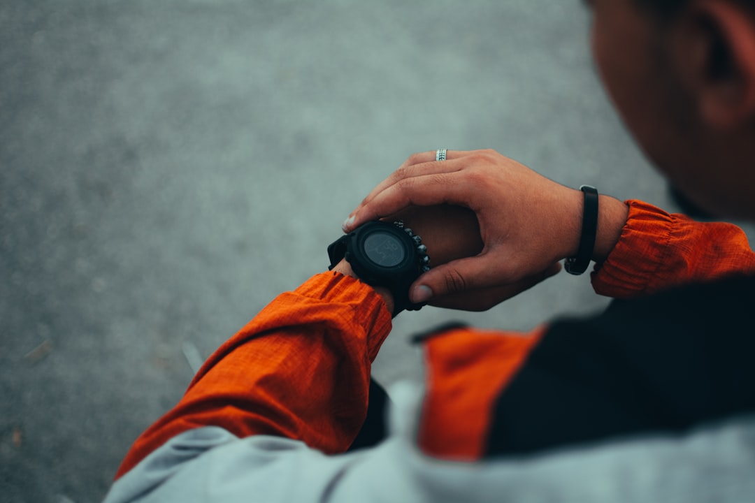 Runner looking at sports watch to monitor pace and heart rate during tempo run workout