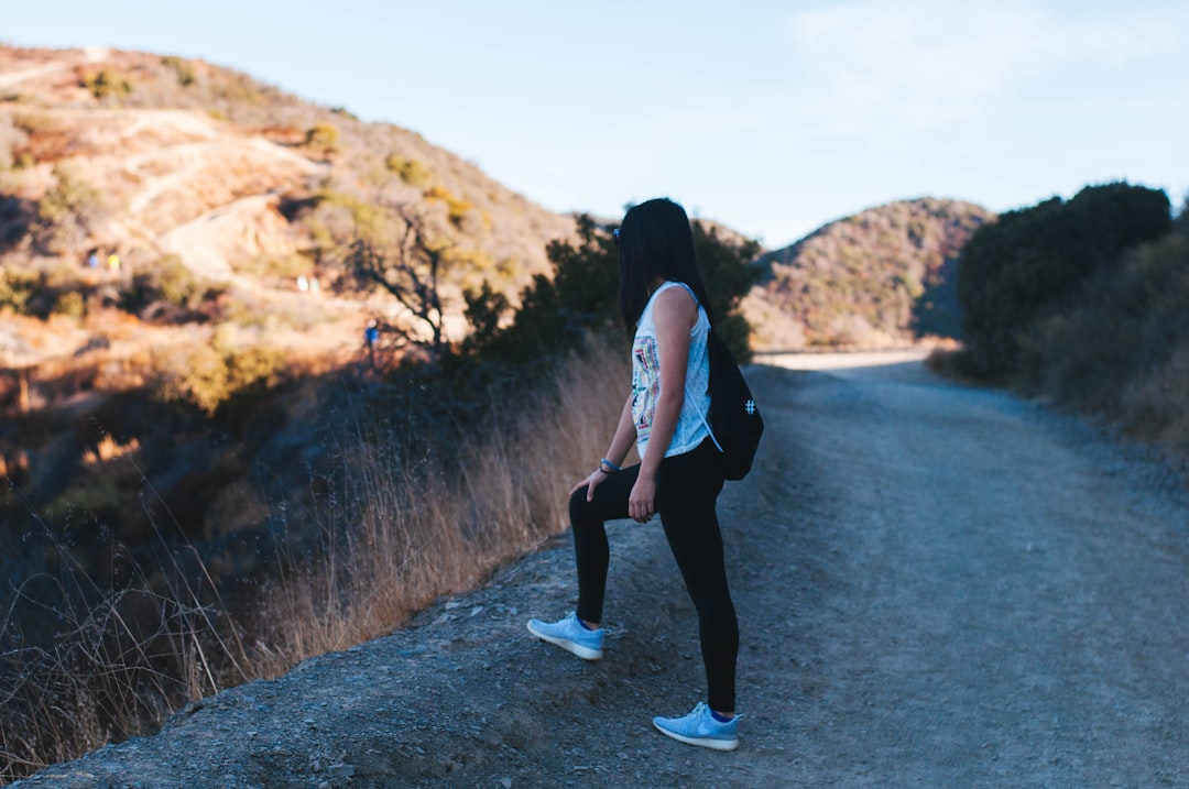 Runner stretching hamstrings and legs after completing a training session