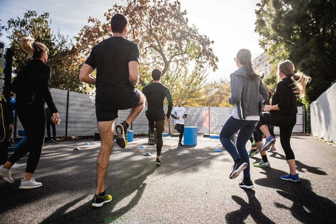 Members of a running club stretching together in a group after their workout, showing camaraderie and community support